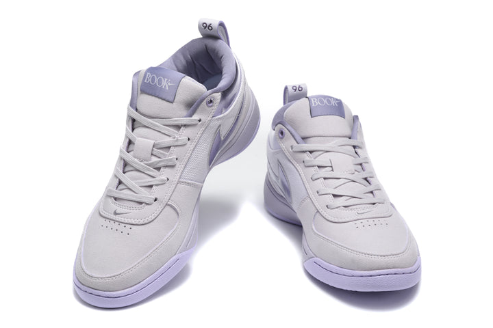 Pair of purple Nike low-top sneakers shown from the front and three-quarter angle.