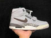 Side profile showing the grey upper, brown Swoosh, elephant-print panel, layered midsole and padded high-top collar.