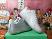 Angled view of white sneakers showing mesh side panels and translucent-looking sole sections
