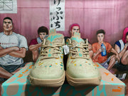 Front view of the Puma sneakers showing tonal laces, patterned toe boxes, and the matching colorful shoe box.