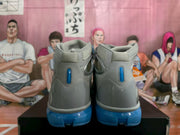 Rear view showing padded collars, heel details, and blue outsole sections