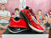 Angled view of the red and black sneakers displayed together, showing the Nike swoosh and white outsoles.