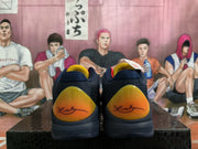 Rear view showing the matching yellow-orange heel panels and dark navy uppers.