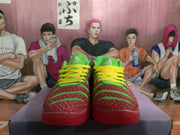 Front view of red and green Nike basketball shoes with yellow laces