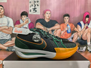 Side profile of a black and dark green Nike basketball shoe with orange accents and a white midsole.