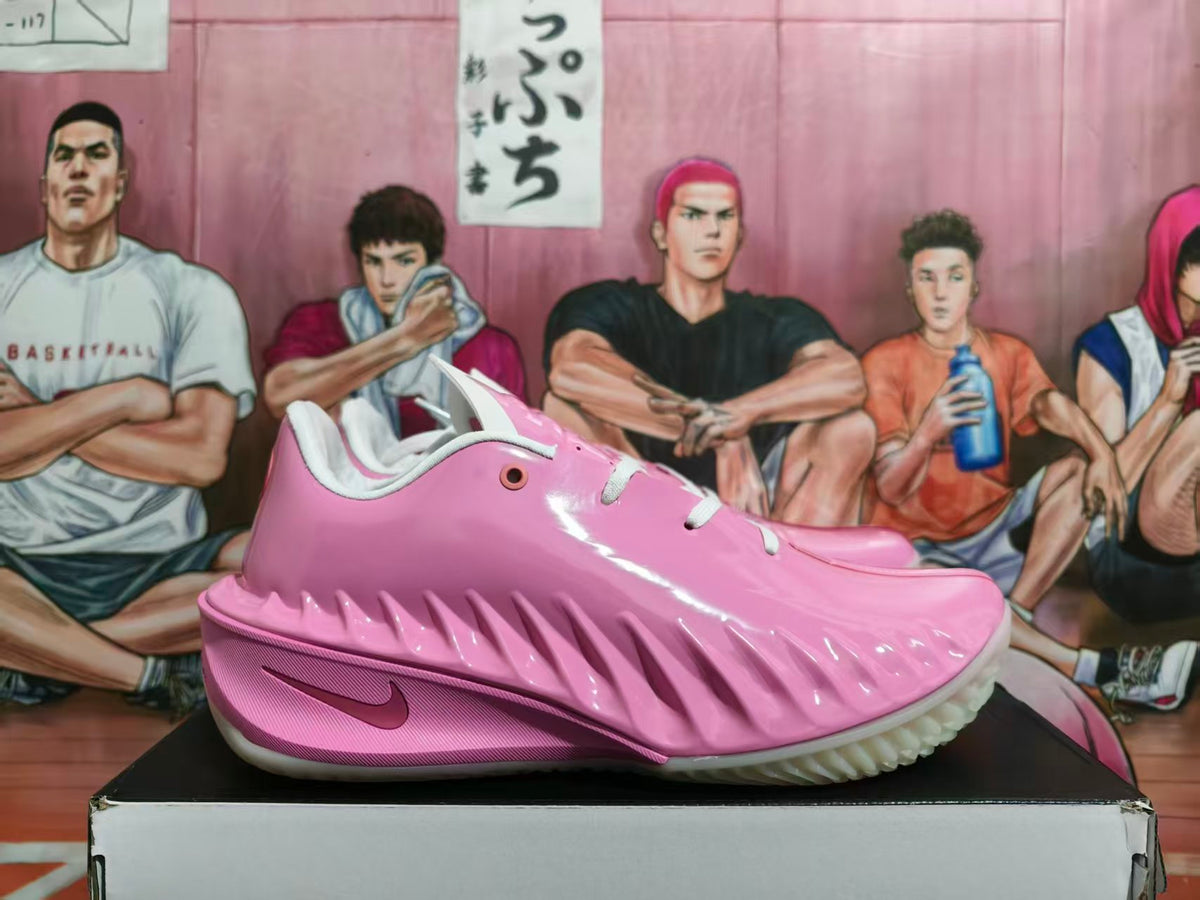 Side view of pink and white Nike GT Cut basketball shoes