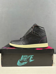 Side profile of a black high-top sneaker with tonal branding, pink accent stitching and a light-colored midsole.