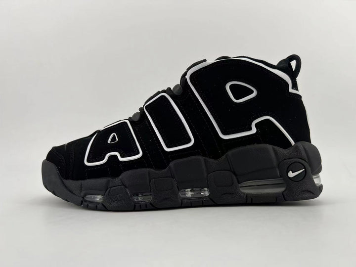 Side view of black Nike Air More Uptempo high-top sneakers with white-outlined lettering and visible cushioning windows.