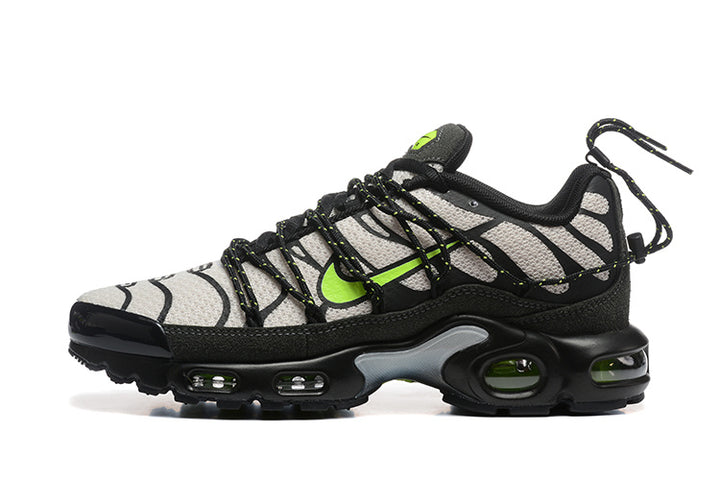 Side view of Nike Air Max Plus sneakers in grey, black and volt