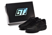 Black Nike sneakers photographed beside a black GTJ-labeled shoe box.