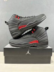 Pair of black and red high-top sneakers arranged on a Jordan-branded shoebox.