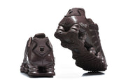 Rear and outsole views of dark brown Nike Shox TL sneakers.