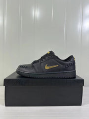 Opposite side profile of the black low-top sneaker with gold-tone side branding and black outsole.