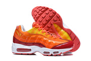 Nike Air Max 95 TT sneakers showing the red outsole and orange-red upper