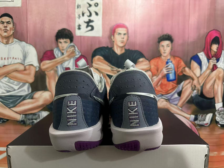 Rear view of dark gray Nike basketball shoes with light gray midsoles and purple outsole accents.
