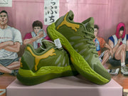 Angled view showing the pair of khaki green sneakers, layered upper panels and yellow heel detailing.