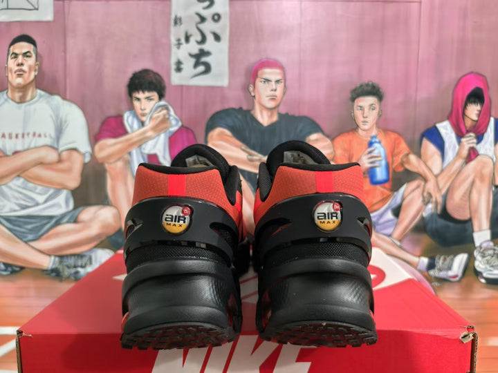 Rear view of black and red Nike sneakers showing Air Max heel badges and rounded outsole elements.