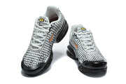 Front view of grey and black Nike Air Max Plus VII sneakers with lace-up closures.