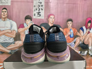 Rear view of the Nike sneakers showing dark blue heel panels, raised details, and translucent outsole sections.