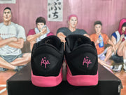 Rear view showing black heel panels with pink script branding and pink midsoles.