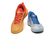 Blue and orange mismatched low-top sneakers shown from the front.