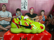Side profile showing the black Swoosh, red and white graphic details, lace-up upper, and ribbed outsole.