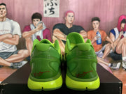 Rear view of green Nike basketball shoes with molded heel counters and lime-toned soles.