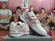 Angled view of white Nike shoes with pink laces and speckled side panels