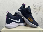 Angled view of a pair of navy, white and purple Nike PG 1 basketball shoes