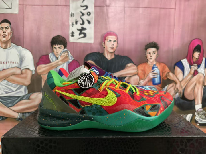 Multicolor mismatched Nike basketball sneakers shown from the side, with bright laces, graphic uppers, and contrasting green and red color blocking.