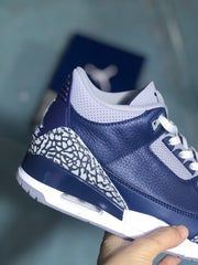 Side close-up of the navy upper, grey collar, and elephant-print heel panel.