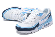 Pair of white, light blue and navy Nike Air Max sneakers shown from above and the side.