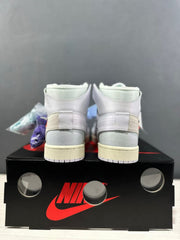 Rear view showing the white collars, beige heel overlays, gray heel panels, and cream midsoles.