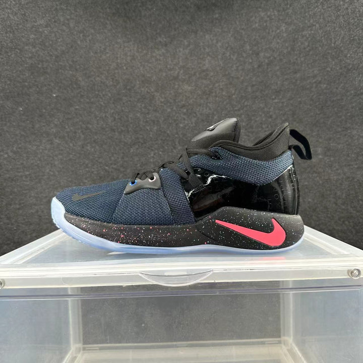 Side view of a black and blue Nike high-top basketball shoe with a pink Swoosh and speckled midsole.