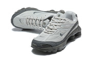 Top and angled front views of grey Nike Shox Ride 2 sneakers.