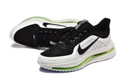 Angled view of black and white Nike Pegasus Premium shoes with green midsole accents.
