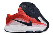 Side view of red and white Nike GT Hustle 3 with patterned white panels and dark accents.
