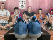 Rear view showing the blue textured uppers, heel panels, and light-colored outsoles.