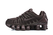 Side view of a dark brown Nike Shox TL sneaker with mesh panels and a segmented sole.