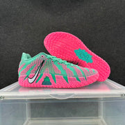 Blue and pink Nike basketball sneakers shown from the side with one outsole facing upward.