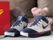 Front three-quarter view of the matching pair with navy toe caps, laces, ankle straps, and red midsole accents.