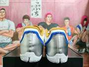 Rear view of the shoes with metallic silver heel panels, blue accents, and white outsoles.