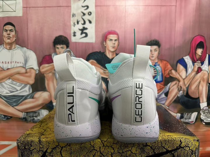 Rear view of white Nike PG 6 basketball shoes showing Paul George heel branding and speckled midsoles.