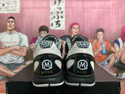 Rear view of the pair showing patterned collars and heel graphics reading Kobe and Gigi.