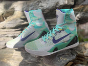 Angled view of the Nike Kobe 9 pair with turquoise laces