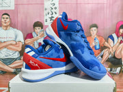 Angled view of the blue and red Nike basketball sneakers showing the outsole and side branding.