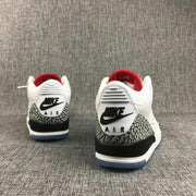 Rear view of the pair with visible black Nike Air branding, white heel panels, and elephant-print overlays.