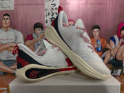 Angled view of the pair highlighting the layered white, red, navy, and cream color design.