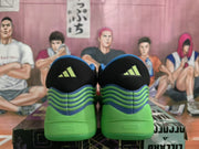 Rear view showing Adidas logos on the black heel panels and layered green and blue heel detailing.