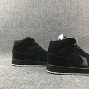 Pair of black mid-top sneakers shown from the side, highlighting the Swoosh panels and white outsole edges.